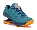Blue athletic shoe with yellow sole on a white background